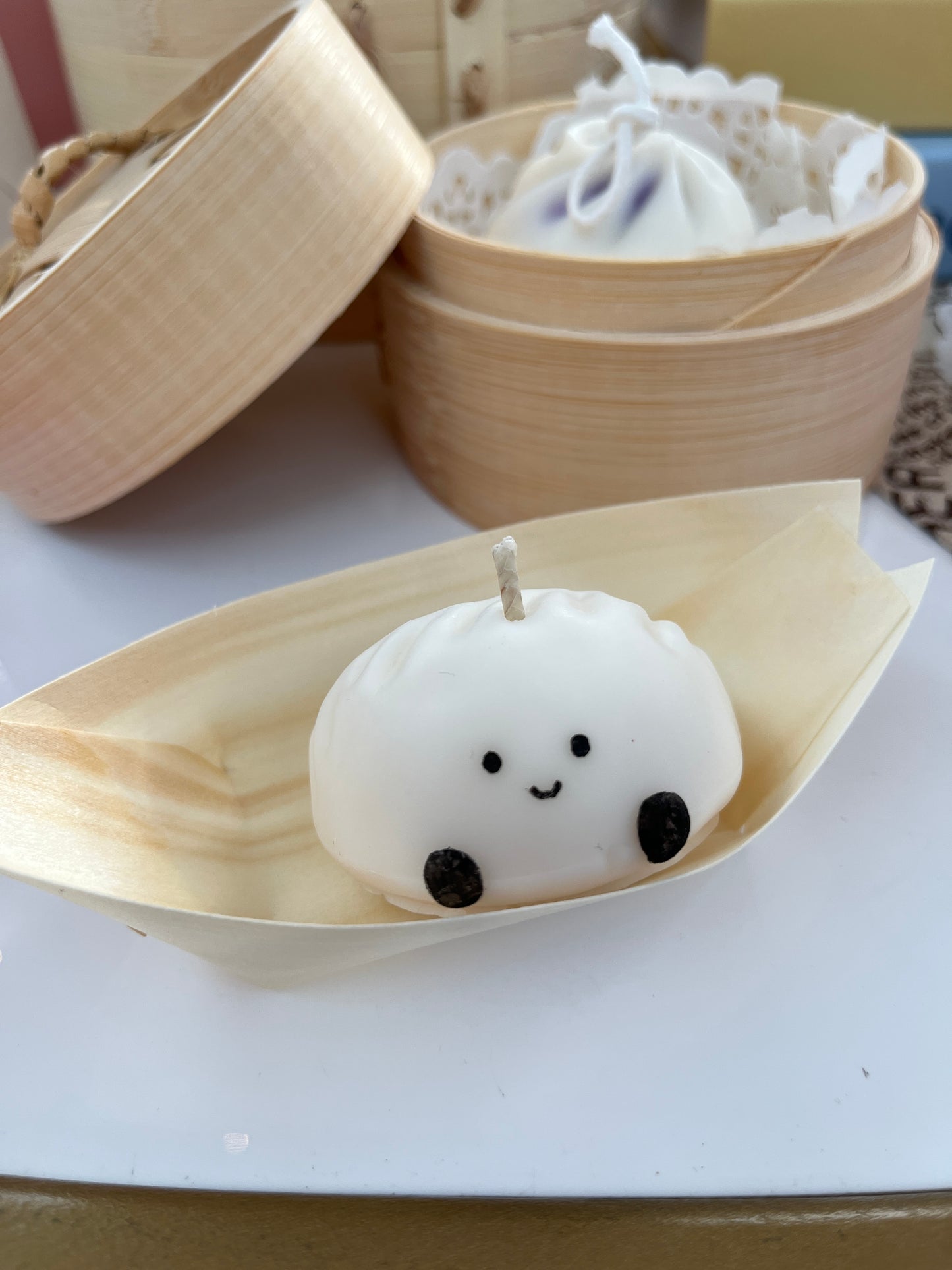 Handmade dumpling-shaped soy wax candle with a face so sweet, you'll hesitate to light her (but do it anyway, he loves the drama)